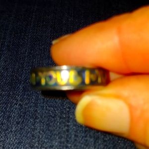 Gold and silver ring says i live you across the band